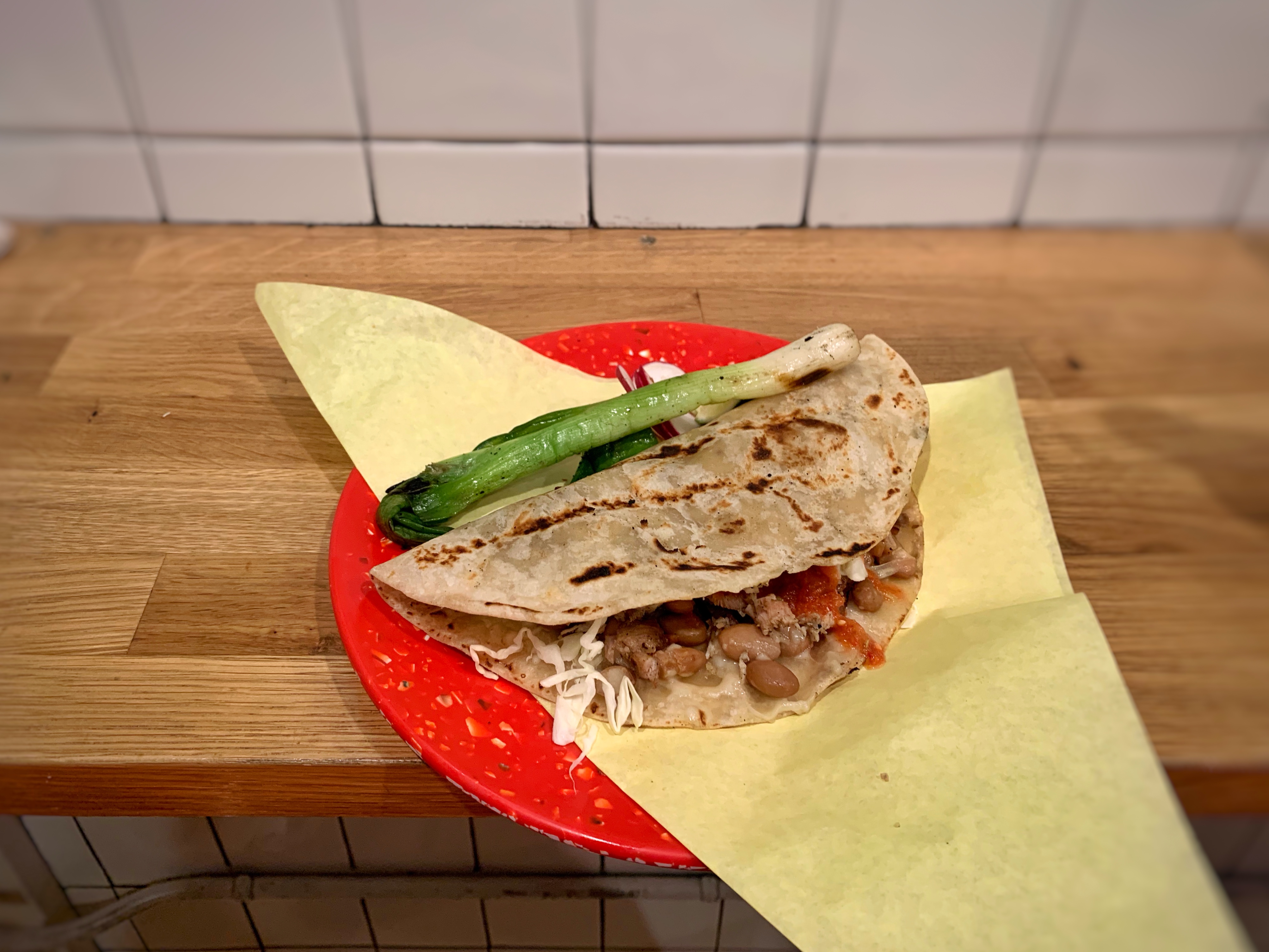 Carne asada taco in a flour tortilla at Sonoratown, with a grilled spring onion