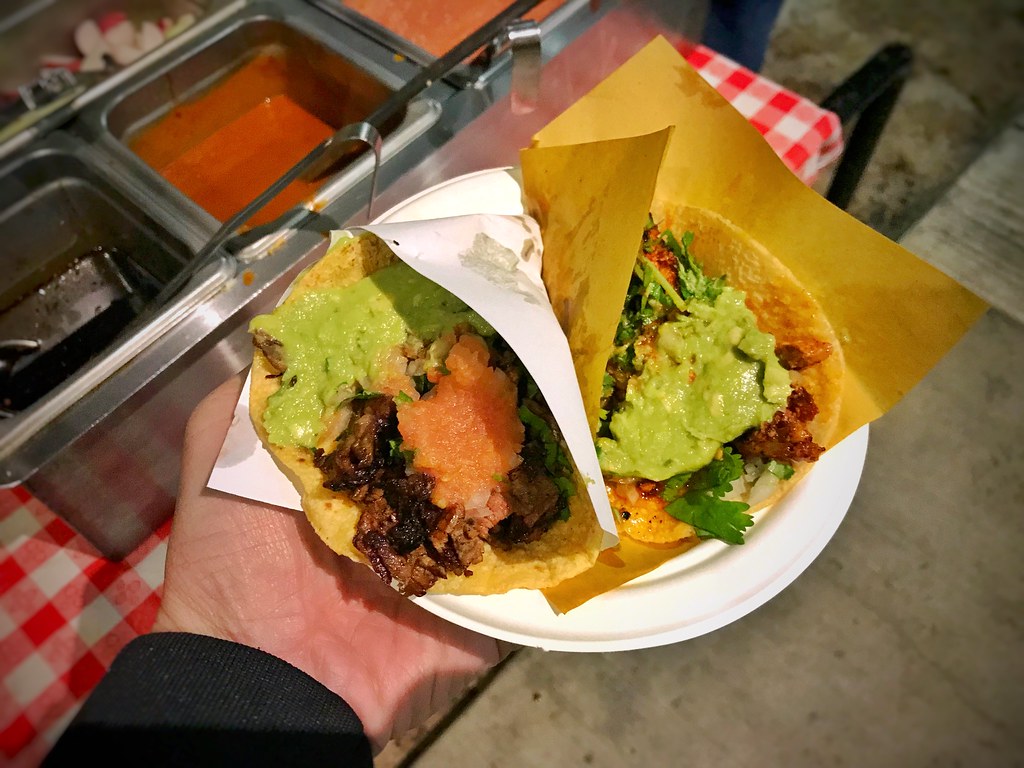 Adobada and carne asada tacos at Tacos 1986 topped with guacamole